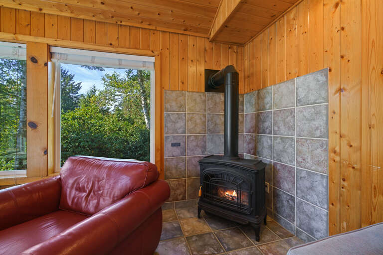 Upstairs open living space with Cable TV, gas fireplace, 2 sleeper sofas, fully stocked kitchen, and dining area. Access to front deck with BBQ. 