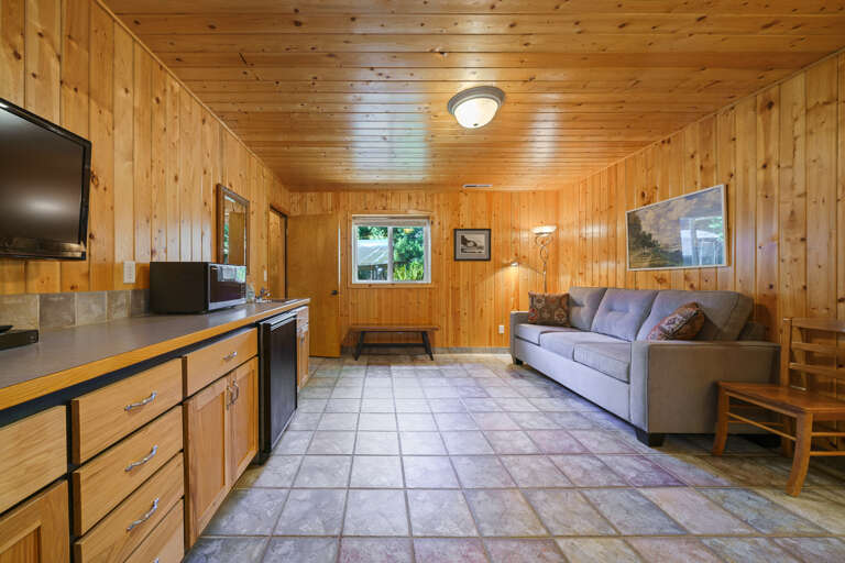 Downstairs den with cable tv, wet bar with sink, mini fridge, microwave and queen sofa bed. 