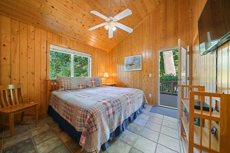 Upstairs King room with cable TV, access to back deck. 