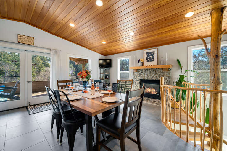 Dining table for 6 plus Bar seating. Open to the Living room with Streaming TV, Gas Fireplace, Access to upper deck.  Dining table for 6 plus Bar seating. Open to the Living room with Streaming TV, Gas Fireplace, Access to upper deck.