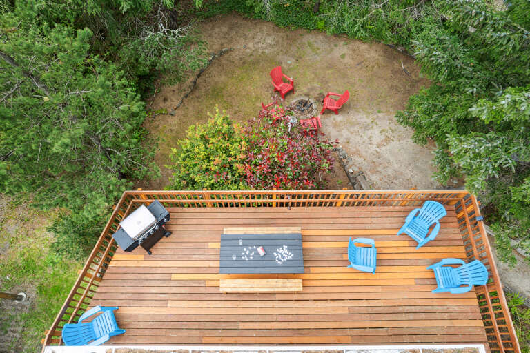 Back deck with picnic table. Perfect for puzzles, dominos etc. Adirondack chairs for lounging and gas BBQ for outdoor grilling. 