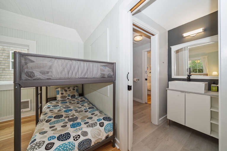 Second bedroom with Queen bed and a set of twin bunks with access to shared bath. 