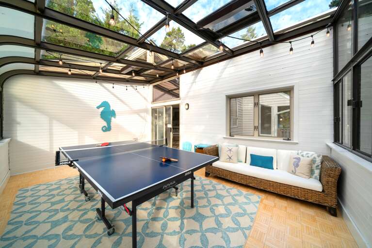 Sunroom with ping pong table and couch