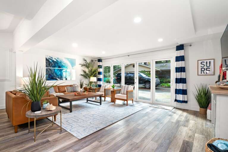 Newly remodeled family room with panoramic doors that open fully. With drink fridge, Foos ball, Air hockey, Smart TV, electric fireplace, and comfy lounge area. 