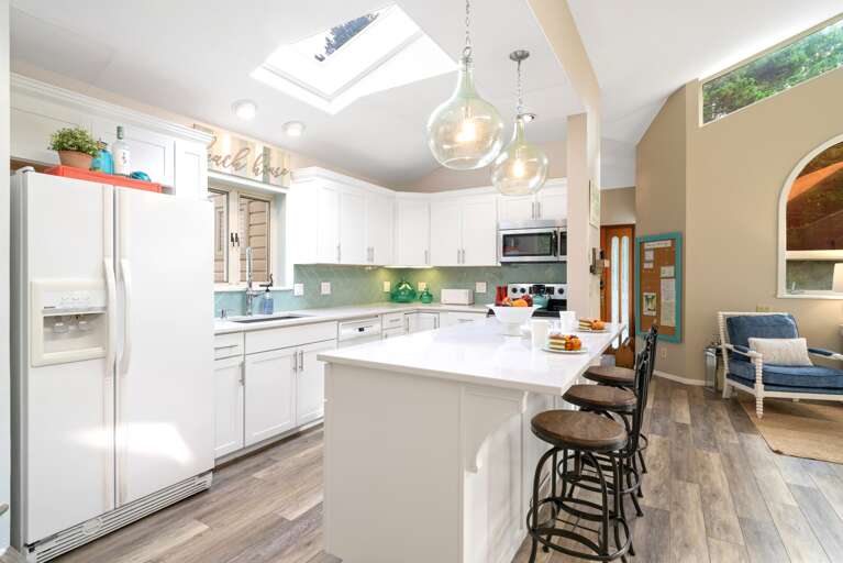 Spacious kitchen with ample counterspace and breakfast bar with three additional seats at the counter.