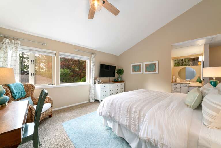 Master bedroom with King, Craft-matic adjustable bed, flat screen TV attached master bath and walk in closet.