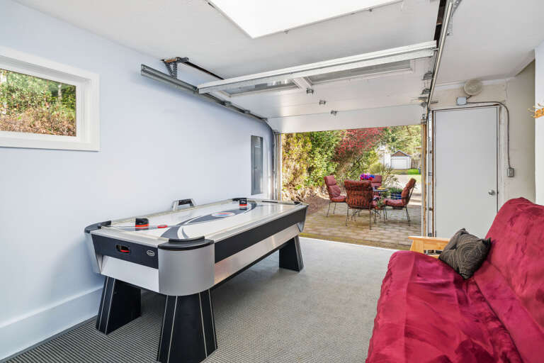 Garage game room with Air hockey and futon. Door opens out to the courtyard