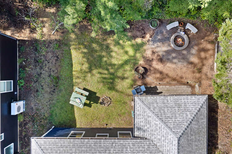aerial view of back yard with picnic table, firepit, and Gas BBQ. 