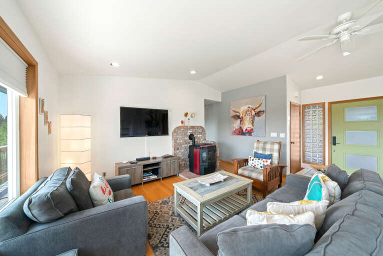 First floor with 3 bedrooms, kitchen, dining, living area, and access to outdoor space and garage. 
Living room with pellet stove, streaming TV. 