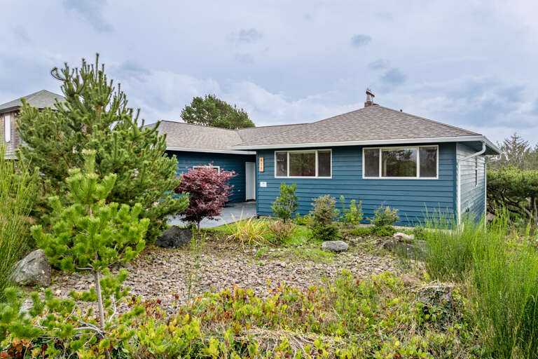 Natural landscaping surrounds the home. 