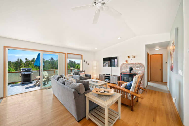 First floor with 3 bedrooms, kitchen, dining, living area, and access to outdoor space and garage. 
Living room with pellet stove, streaming TV. 