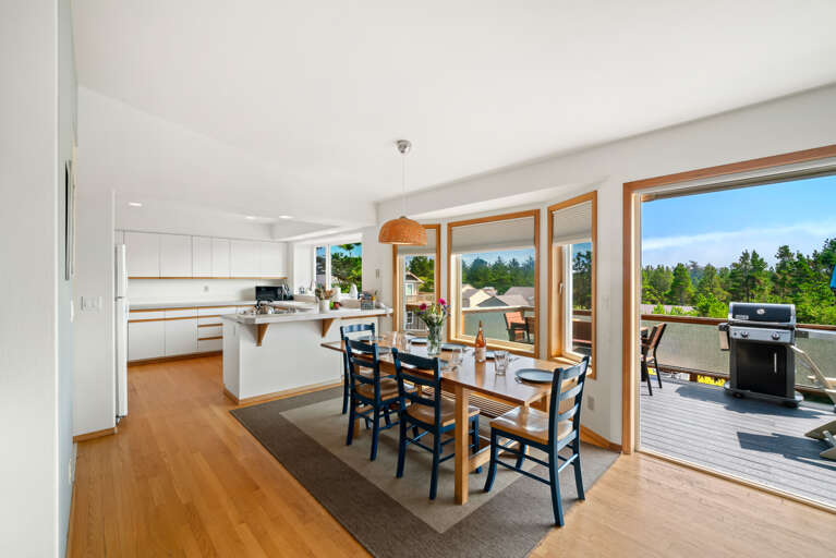 First floor with 3 bedrooms, kitchen, dining, living area, and access to outdoor space and garage. 
Living room with pellet stove, streaming TV. 