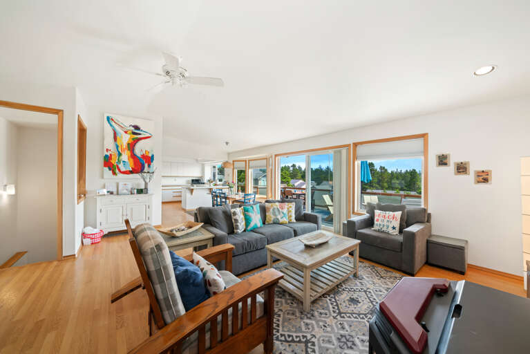 First floor with 3 bedrooms, kitchen, dining, living area, and access to outdoor space and garage. 
Living room with pellet stove, streaming TV. 