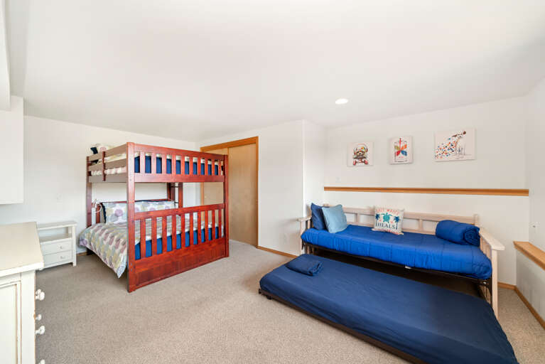Downstairs bunk room with double size bunk beds, and a twin trundle with pull out twin. 