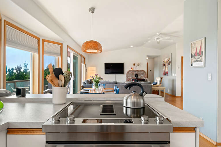 First floor with 3 bedrooms, kitchen, dining, living area, and access to outdoor space and garage. 
Living room with pellet stove, streaming TV. 