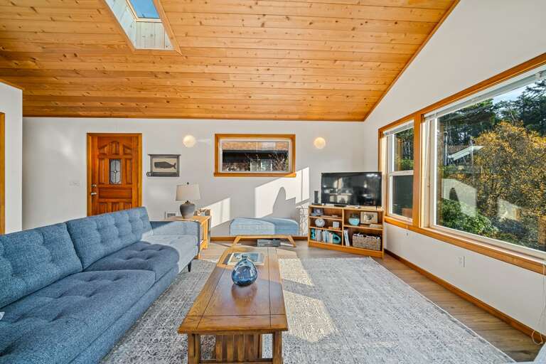 Upstairs open living area with access to the deck. Woodstove, Smart TV, WIFI, DVD, Books