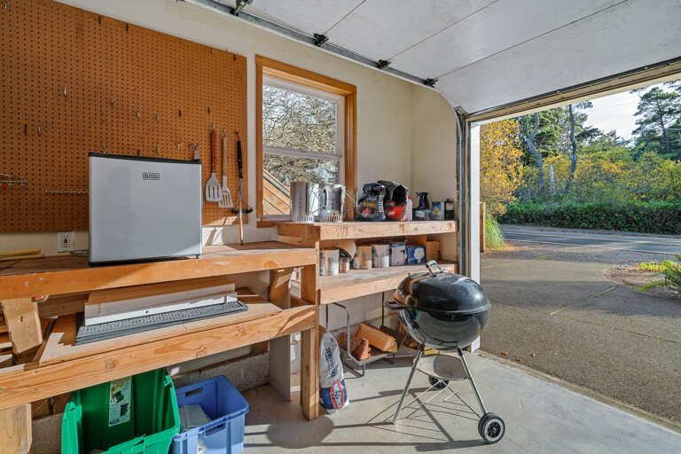 Garage with charcoal BBQ, Kites, and mini fridge