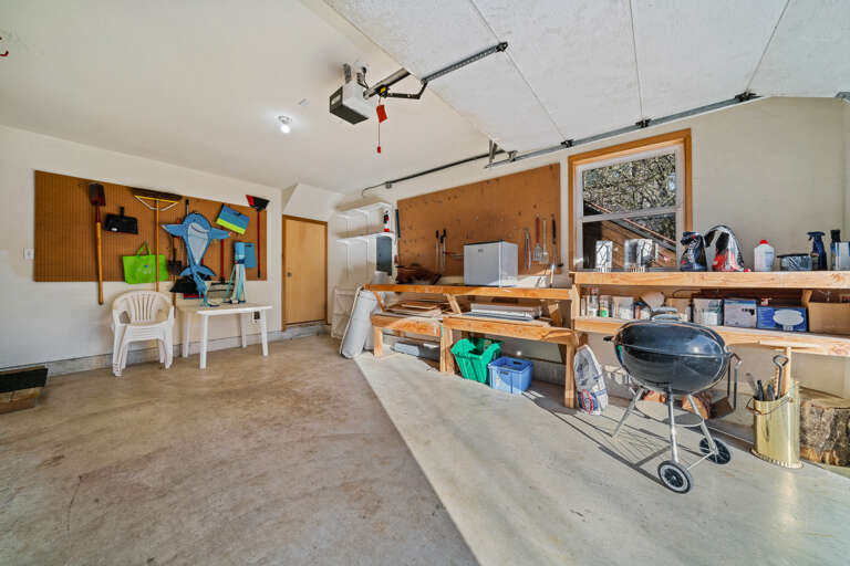 Garage with charcoal BBQ, Kites, and mini fridge. 