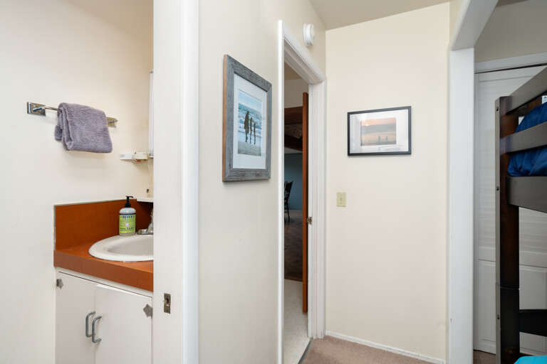 Bunk room with 2 bunks, 1/2 bath with toilet and sink, 1/2 bath with Shower, Cable TV. 