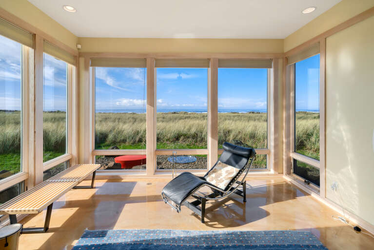 Living room with gas fireplace, Direct TV, Ocean views, Surround sound, Overhead fans, open to dining area.