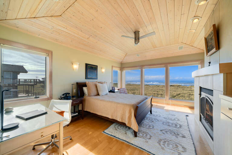 Master Bedroom with spectacular ocean views, gas fireplace, luxury linens, overhead fans, desk workspace. attached master bath with Jacuzzi tub, double sinks, nespresso coffee station. 