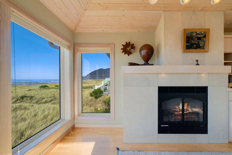 Master Bedroom with spectacular ocean views, gas fireplace, luxury linens, overhead fans, desk workspace. attached master bath with Jacuzzi tub, double sinks, nespresso coffee station. 