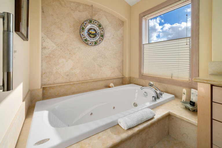 Master Bedroom with spectacular ocean views, gas fireplace, luxury linens, overhead fans, desk workspace. attached master bath with Jacuzzi tub, double sinks, nespresso coffee station. 