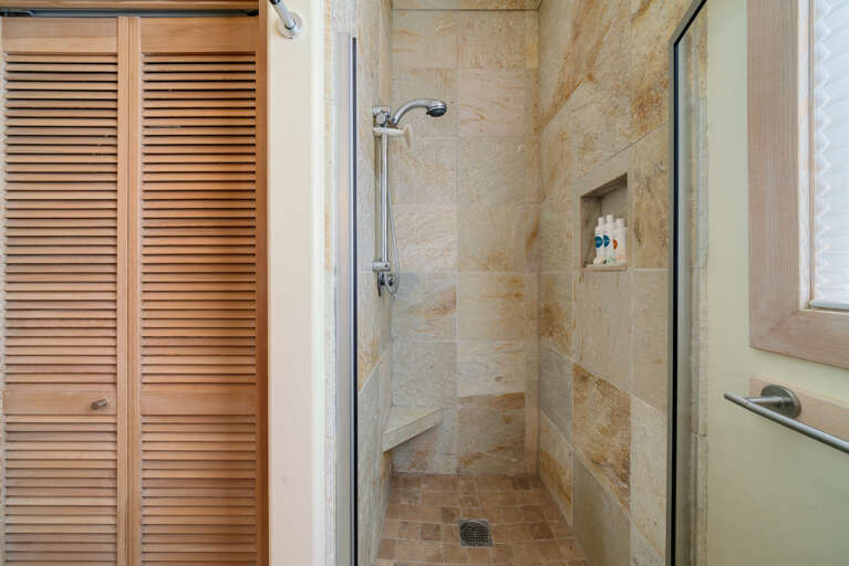 Downstairs full bath with Walk-in Shower and Stackable Washer and Dryer. 