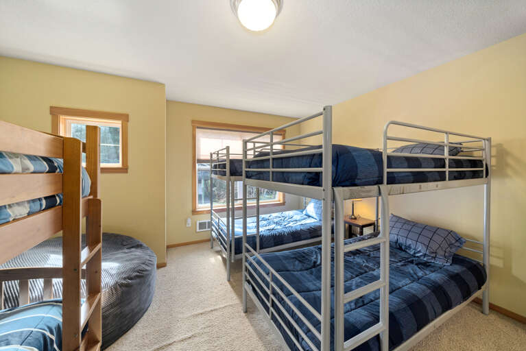 Bunk room with 3 sets of bunk and a twin mattress.
