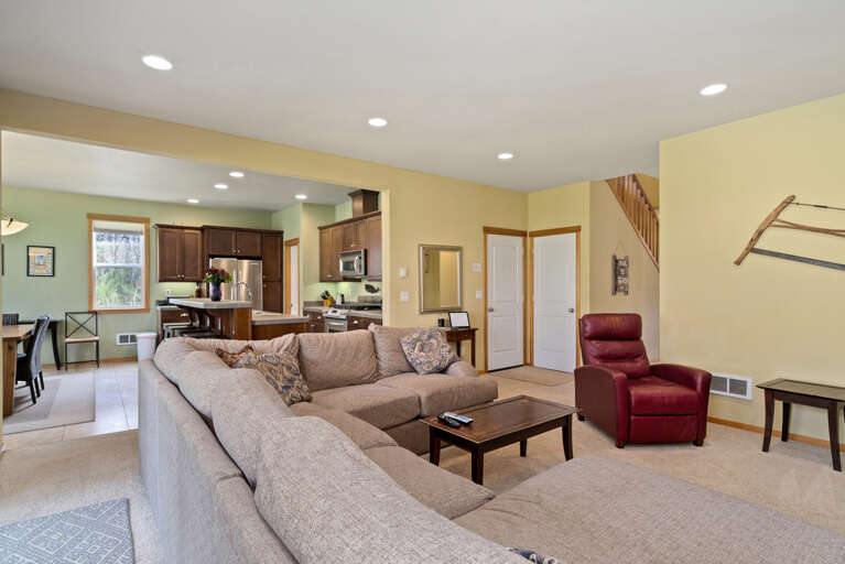 Fully equipped kitchen open to the dining room and living room with fireplace, TV, large cozy couch, access to back yard with firepit. 