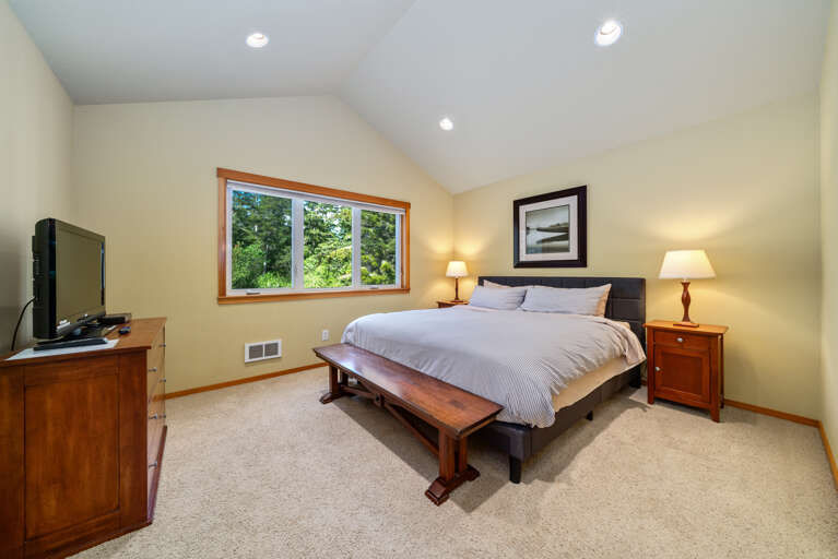 Upstairs master with King bed, streaming TV, and Attached Master bath with shower walkin. 