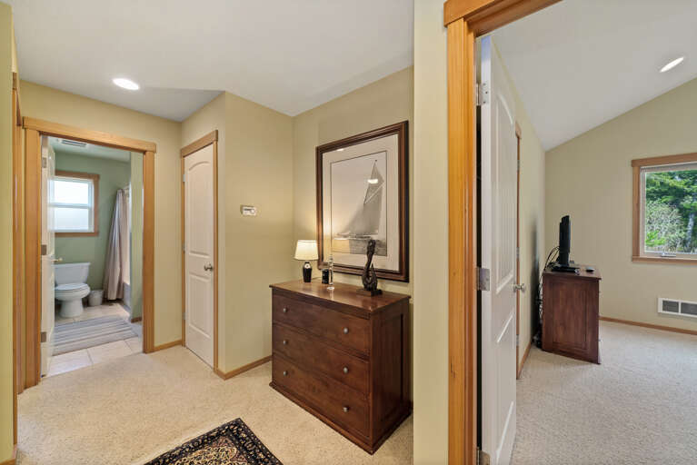 Hallway between 3 bedrooms and full bathroom