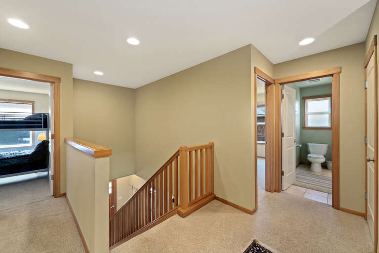 Hallway between 3 bedrooms and full bathroom