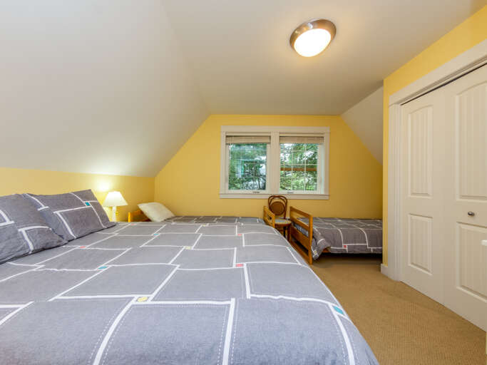 Upstairs bedroom with Queen bed and 2 twin beds. 