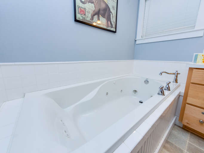 Downstairs master bedroom with queen bed and attached bath with jetted tub.