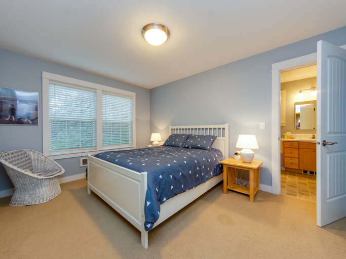Downstairs master bedroom with queen bed and attached bath with jetted tub.