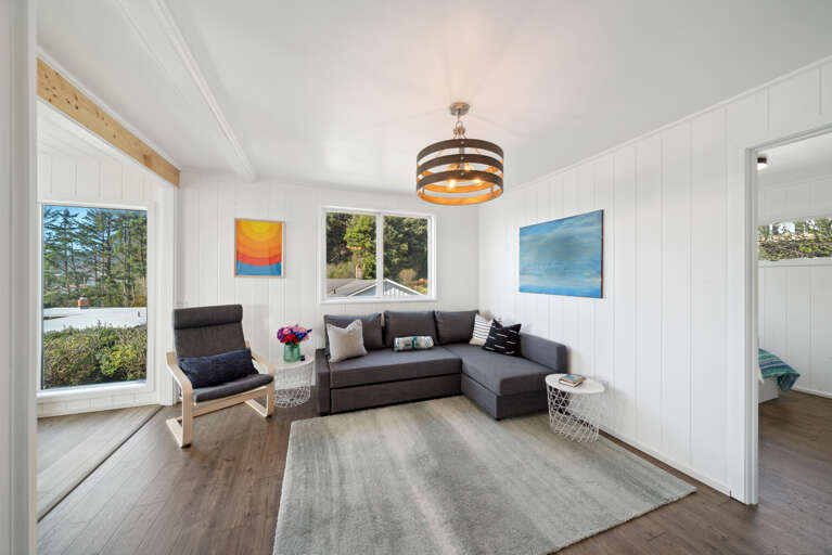 Living room with Smart TV, comfy couch and ocean views