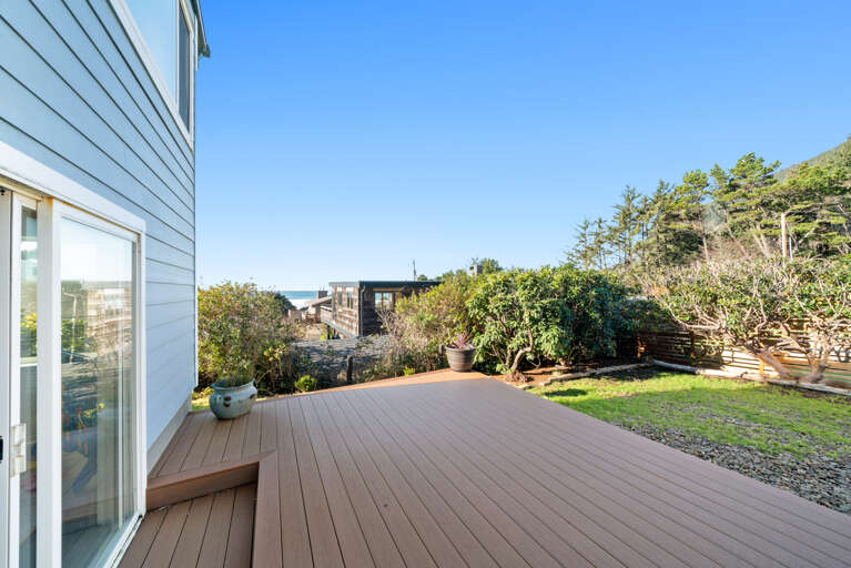 Newly fenced in back yard for your pup with deck