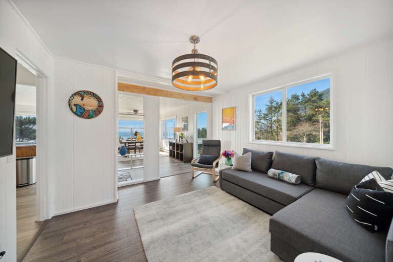 Living room with Smart TV, comfy couch and ocean views