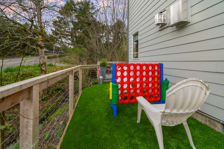 Hot tub on the back deck, with outdoor dining, lounge furniture, Gas BBQ, and fenced in area. 