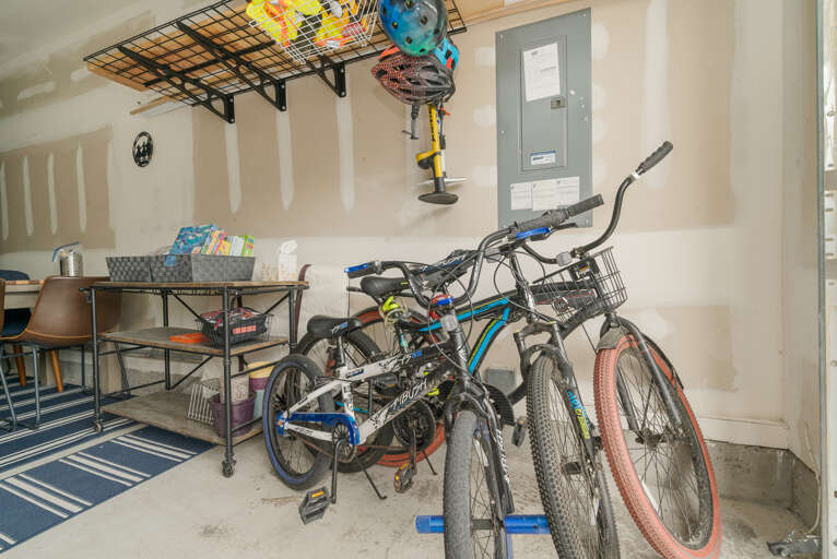 Garage game room with streaming tv, lounge area, airhockey, card table, bikes (not maintained by STS) and beach toys