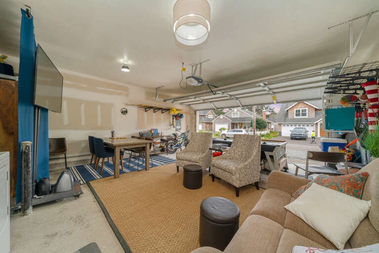 Garage game room with streaming tv, lounge area, airhockey, card table, bikes (not maintained by STS) and beach toys