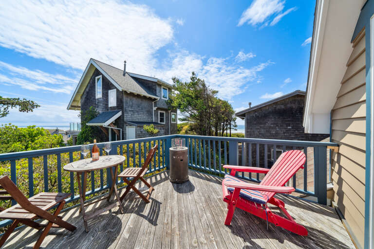  Ocean view deck, outdoor fire table, and bistro table and chairs. 
