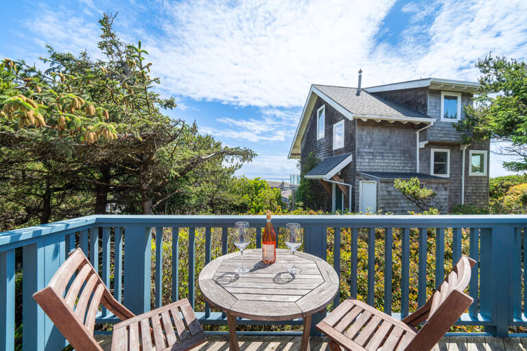  Ocean view deck, outdoor fire table, and bistro table and chairs. 