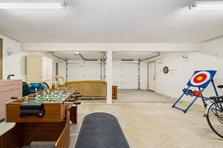  Garage with lounge area, card tables,  beach toys, Beach wagon, Beach chairs, foosball, faux ax throwing, bikes(not maintained by Sunset to Sunset) and darts. 