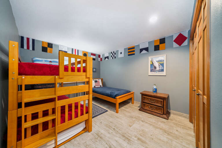 Bunk room with bunk bed with twin trundle and twin bed.