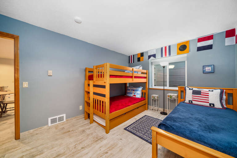 Bunk room with bunk bed with twin trundle and twin bed.