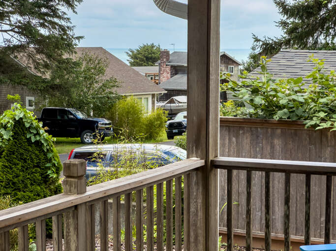 Front covered porch with Adirondack chairs for relaxing in. 