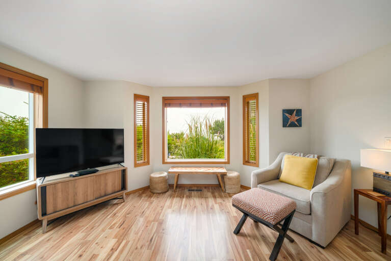 Main floor living room with fireplace, ocean view, Roku w/live TV, DVD player, books, games. 