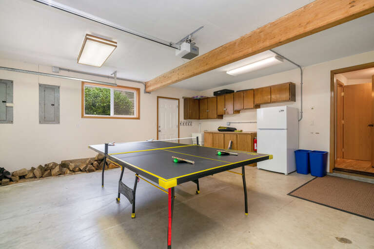 Garage with Ping pong, beach toys, beach chairs, extra fridge, washing sink